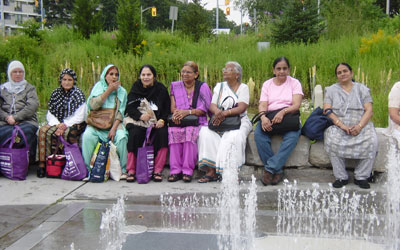 seniors sitting in front of a fountain