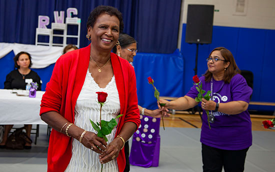 Woman receiving rose at RWC 40th Anniversary