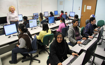 adult students sitting at computers